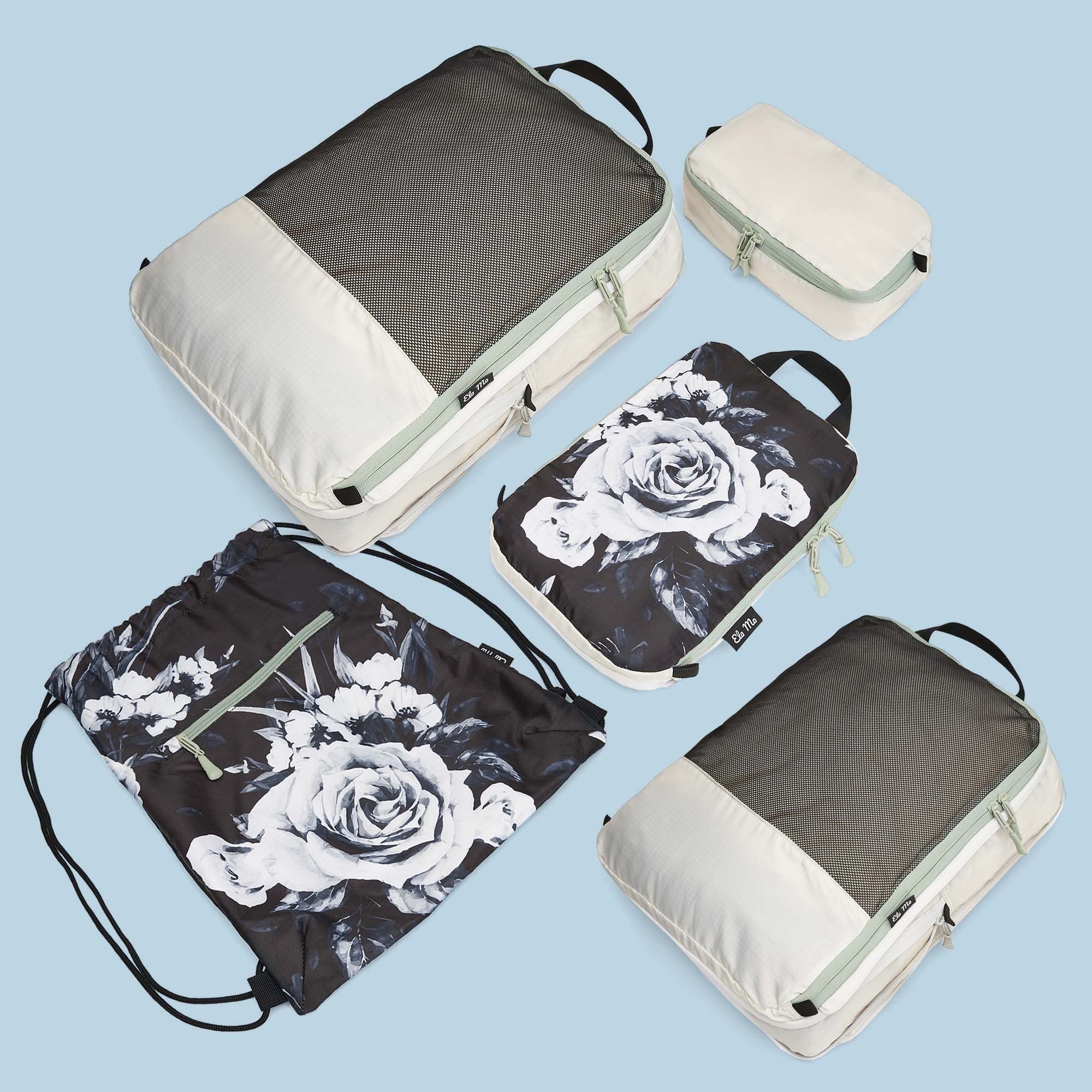 Ela Mo™ Packtaschen-Set | 5-teilig. Fünf kleine Taschen in unterschiedlicher Form, in Grau mit floralem Muster.