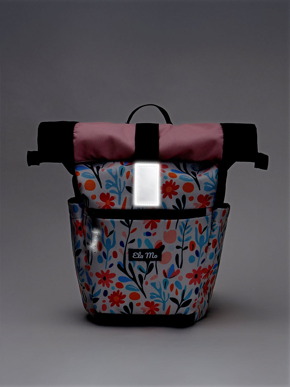 Ela Mo™ Kinderrucksack (6-10 Jahre) | Pastel Land. Floral gemusterter Rucksack in Dunkel mit reflektivem Verschluss.
